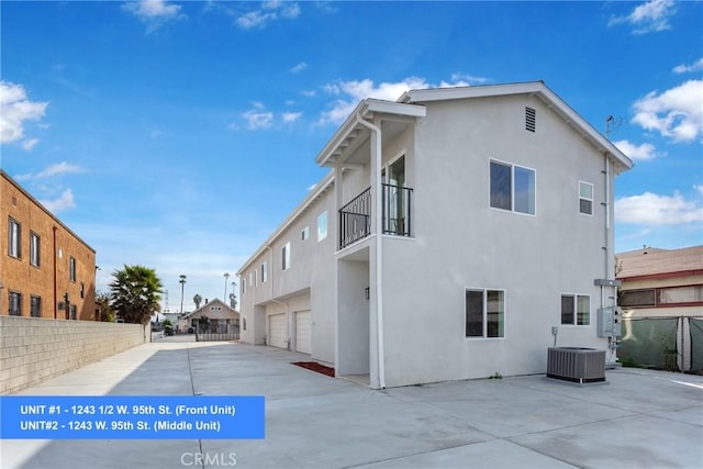 view of home's exterior with central AC and a garage