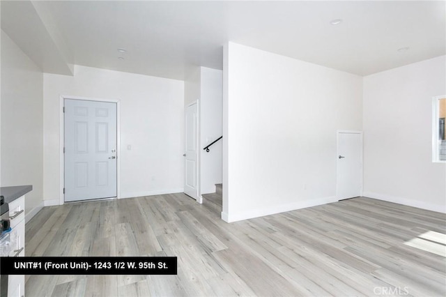 spare room featuring light wood-type flooring