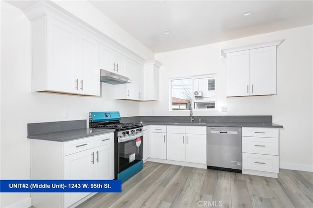 kitchen with appliances with stainless steel finishes, sink, white cabinets, and light hardwood / wood-style floors