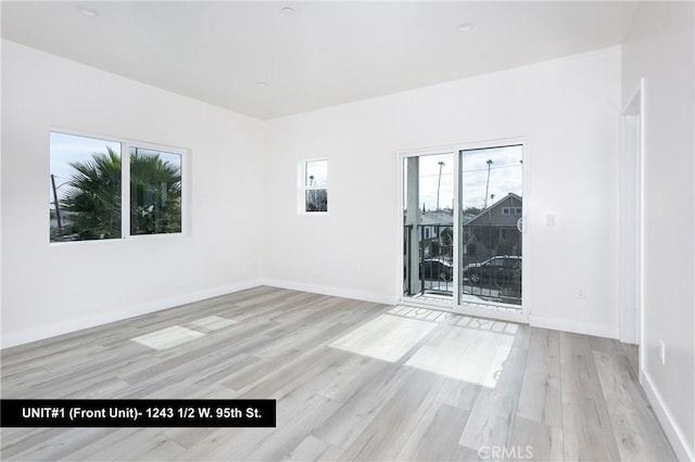 unfurnished room with light wood-type flooring