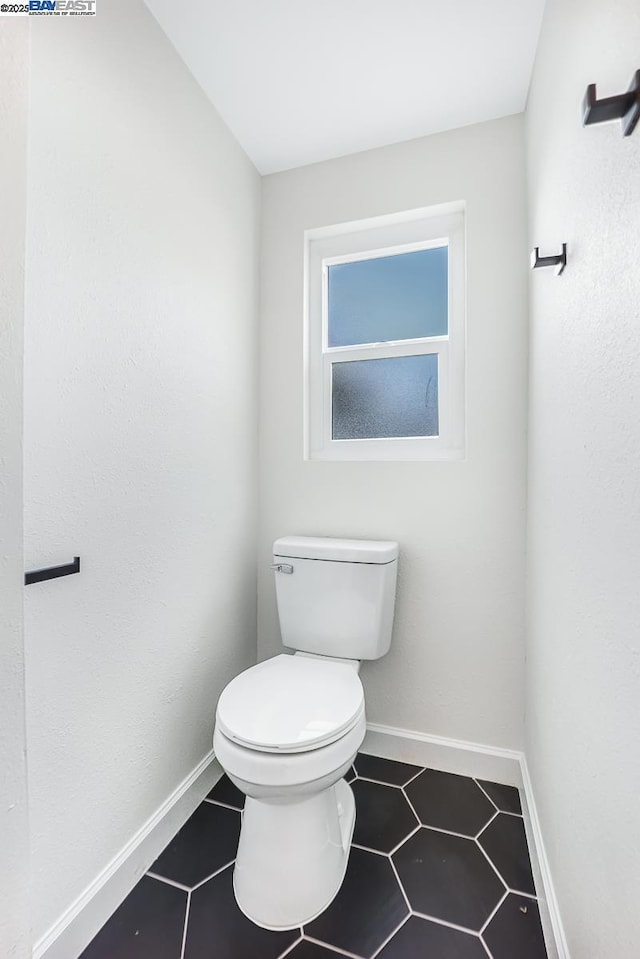 bathroom featuring tile patterned floors and toilet