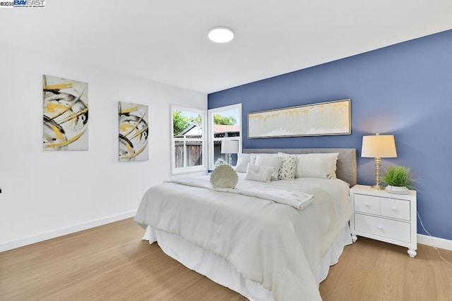 bedroom with hardwood / wood-style flooring