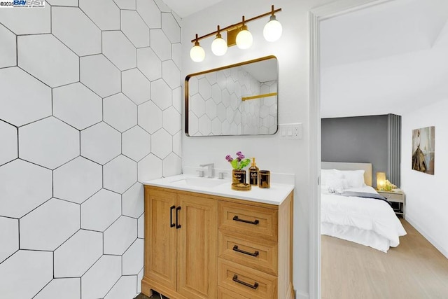 bathroom with vanity and tile walls