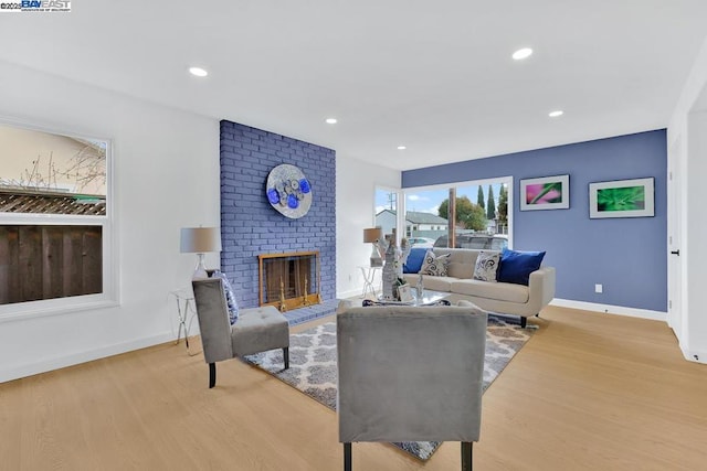 living room featuring a fireplace and light hardwood / wood-style flooring