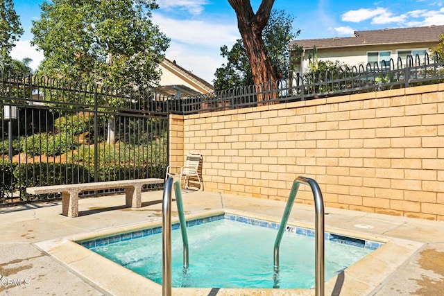 view of pool featuring a hot tub