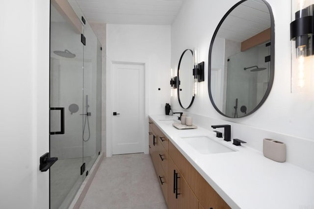 bathroom featuring vanity and a shower with shower door