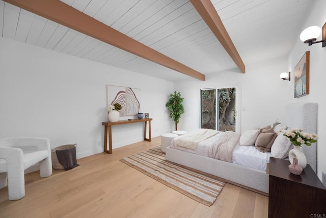 bedroom featuring beamed ceiling and light hardwood / wood-style flooring