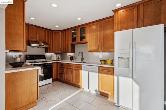 kitchen featuring sink and white appliances