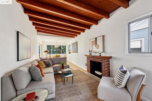 living room featuring a brick fireplace and beamed ceiling