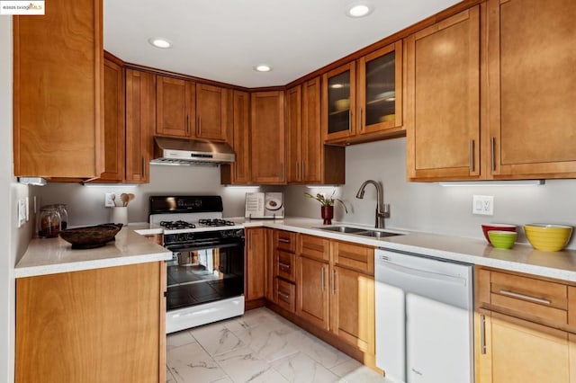 kitchen featuring white dishwasher, sink, and range with gas cooktop