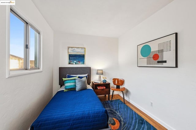 bedroom with hardwood / wood-style floors