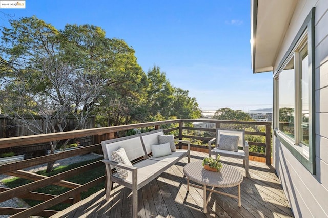 wooden balcony with a wooden deck and outdoor lounge area