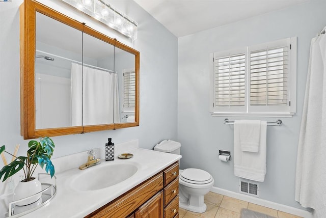 bathroom featuring vanity, tile patterned floors, and toilet