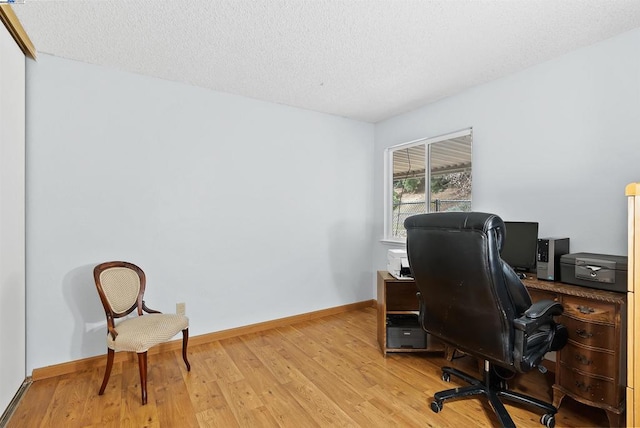 office space featuring light hardwood / wood-style flooring and a textured ceiling