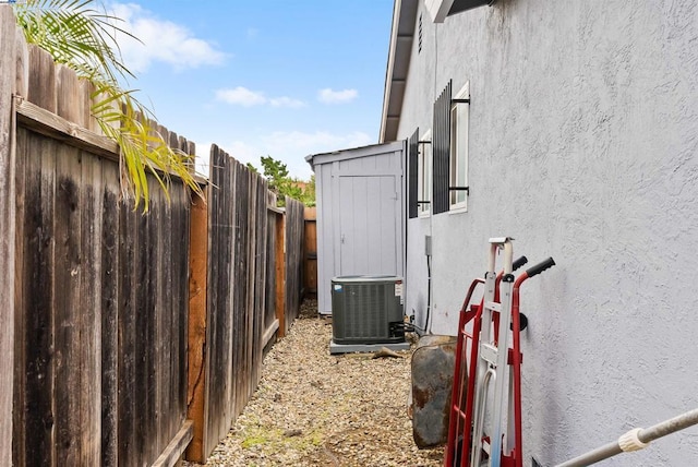 view of side of home with central air condition unit