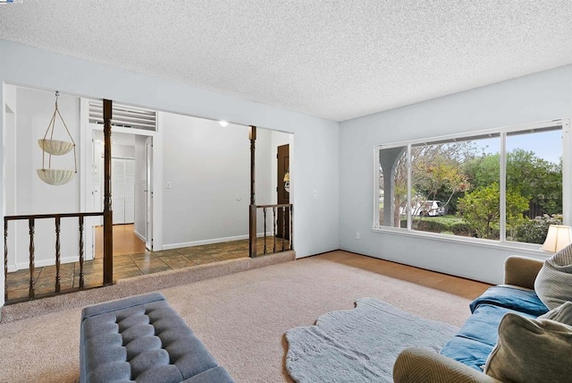 carpeted living room with a textured ceiling