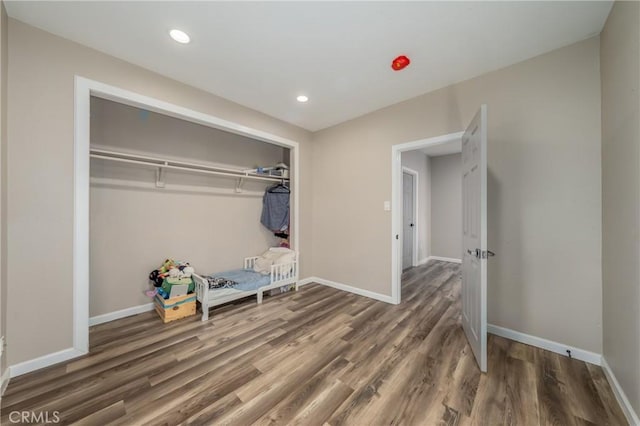 bedroom featuring a closet and dark hardwood / wood-style floors