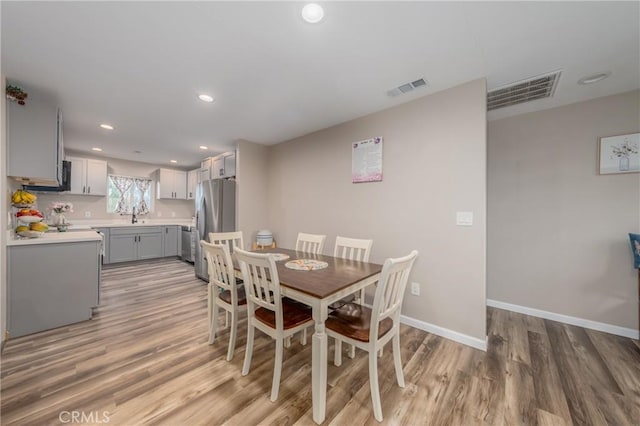 dining space with light hardwood / wood-style floors