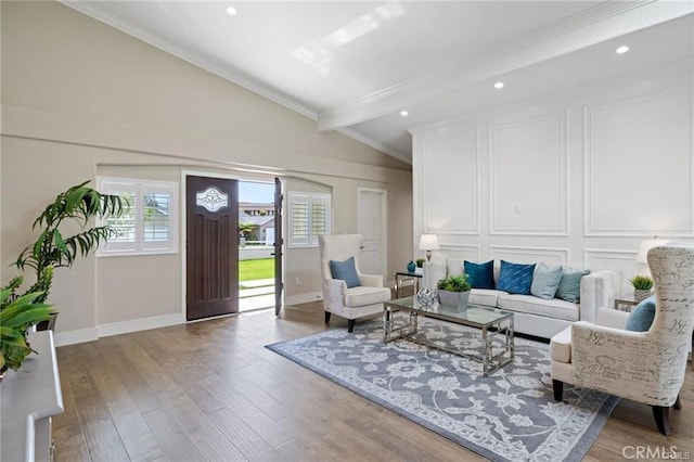 living room featuring hardwood / wood-style floors, crown molding, and lofted ceiling with beams