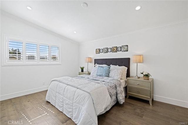 bedroom featuring lofted ceiling, hardwood / wood-style flooring, and ornamental molding