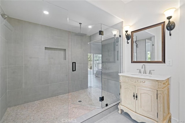 bathroom featuring vanity, tile patterned floors, and walk in shower