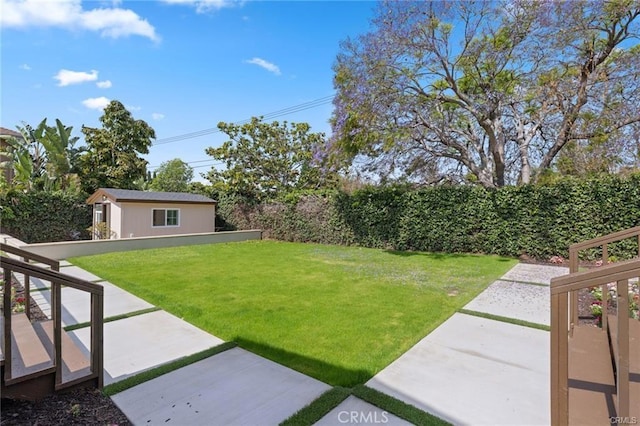 view of yard featuring an outbuilding and a patio area