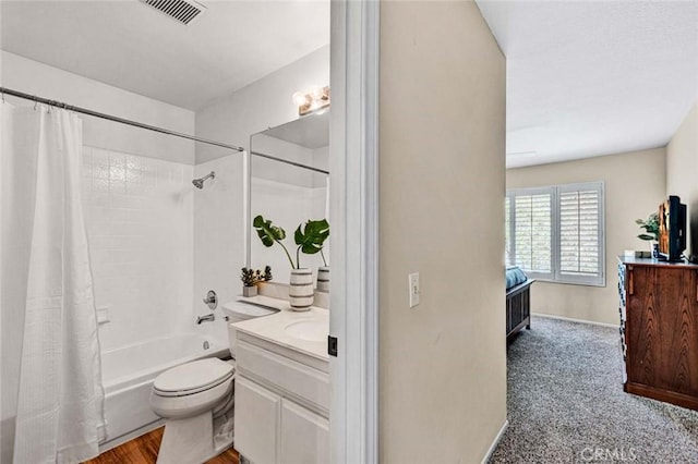 full bathroom with vanity, shower / bath combo, and toilet