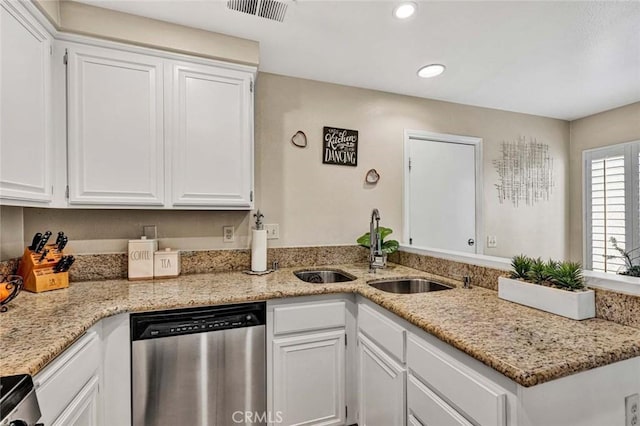 kitchen with white cabinetry, dishwasher, sink, stove, and light stone counters