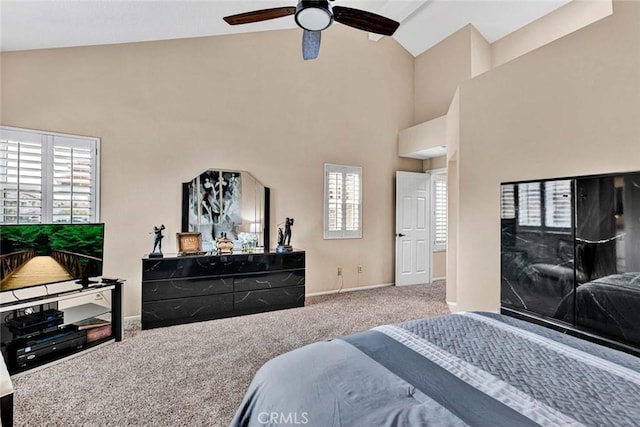 carpeted bedroom with high vaulted ceiling and ceiling fan