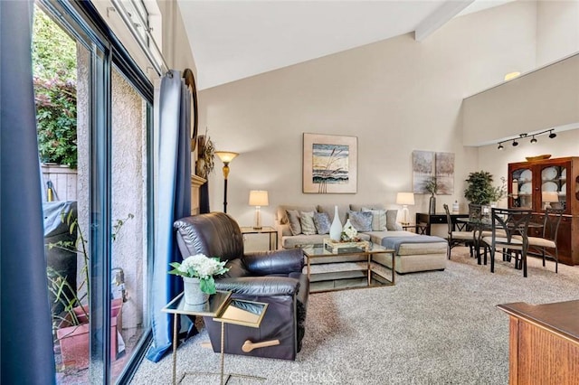 carpeted living room featuring beamed ceiling, rail lighting, and high vaulted ceiling