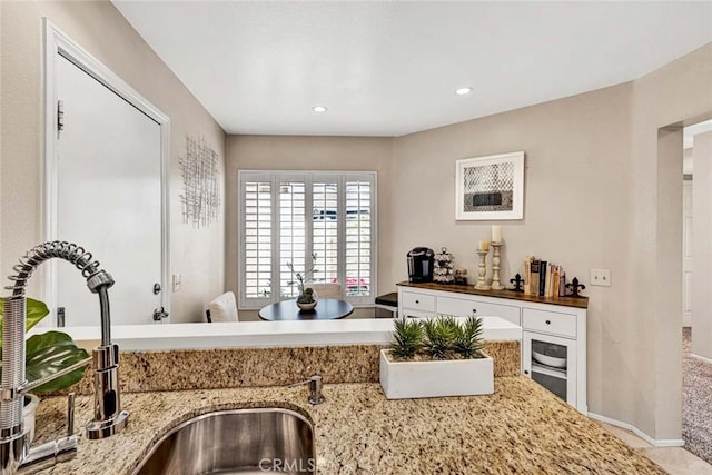 kitchen with light stone counters and sink