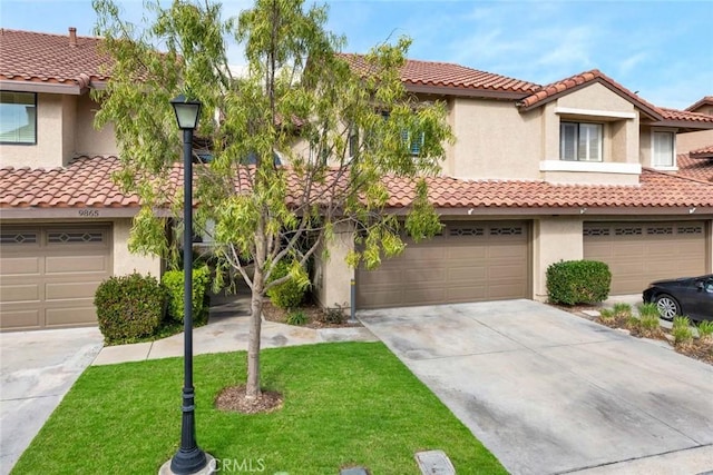 view of front of home featuring a garage and a front lawn