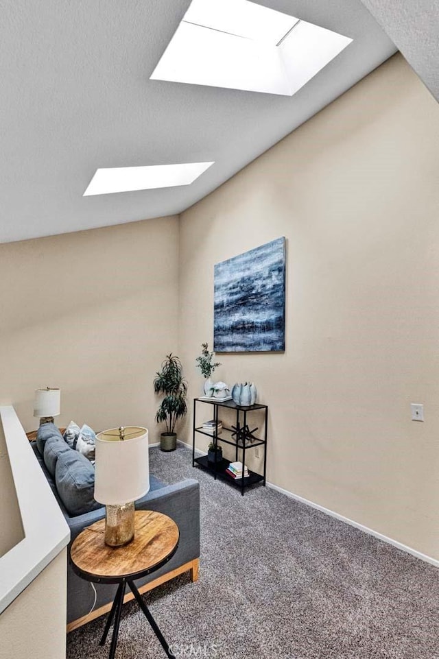 sitting room featuring carpet floors and a textured ceiling