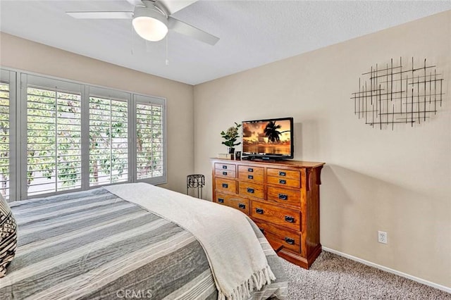 bedroom featuring carpet floors, a textured ceiling, and ceiling fan