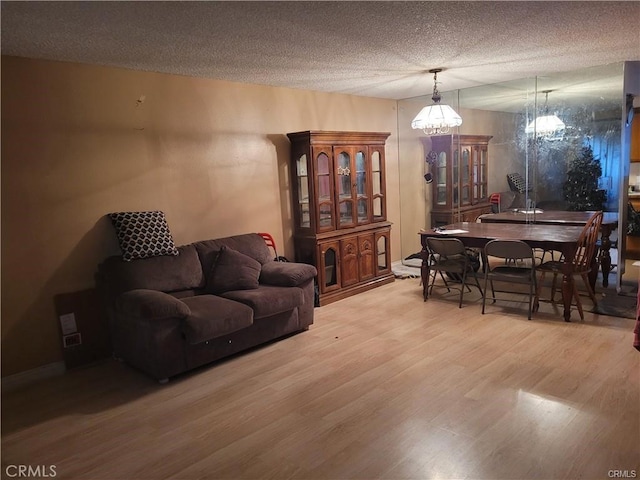 living room with hardwood / wood-style flooring and a textured ceiling