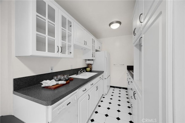 kitchen featuring white appliances, sink, and white cabinets