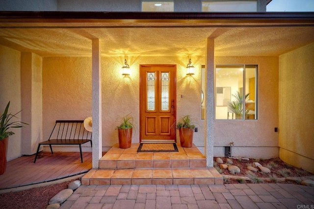 property entrance with stucco siding