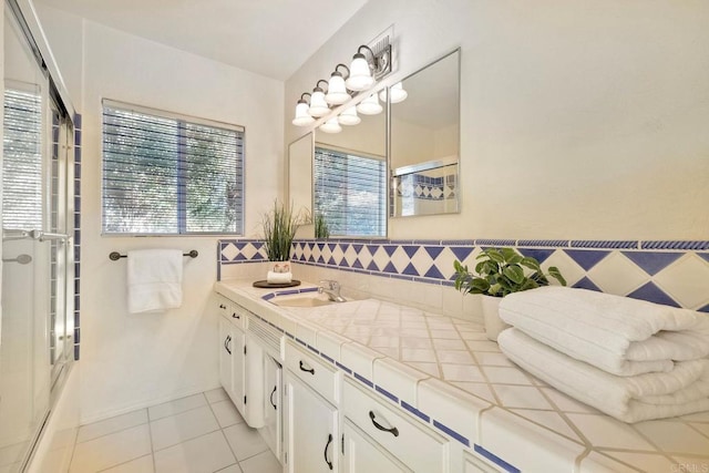 full bathroom featuring tile patterned flooring, vanity, and a shower