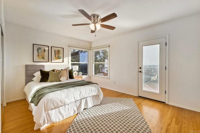 bedroom featuring a ceiling fan, access to outside, baseboards, and light wood-type flooring