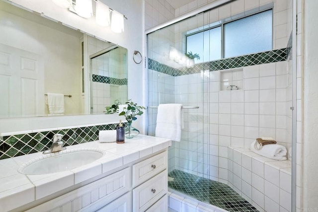 bathroom with a stall shower and vanity