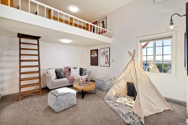 carpeted living room with a towering ceiling