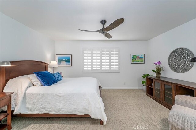 bedroom with light carpet and ceiling fan