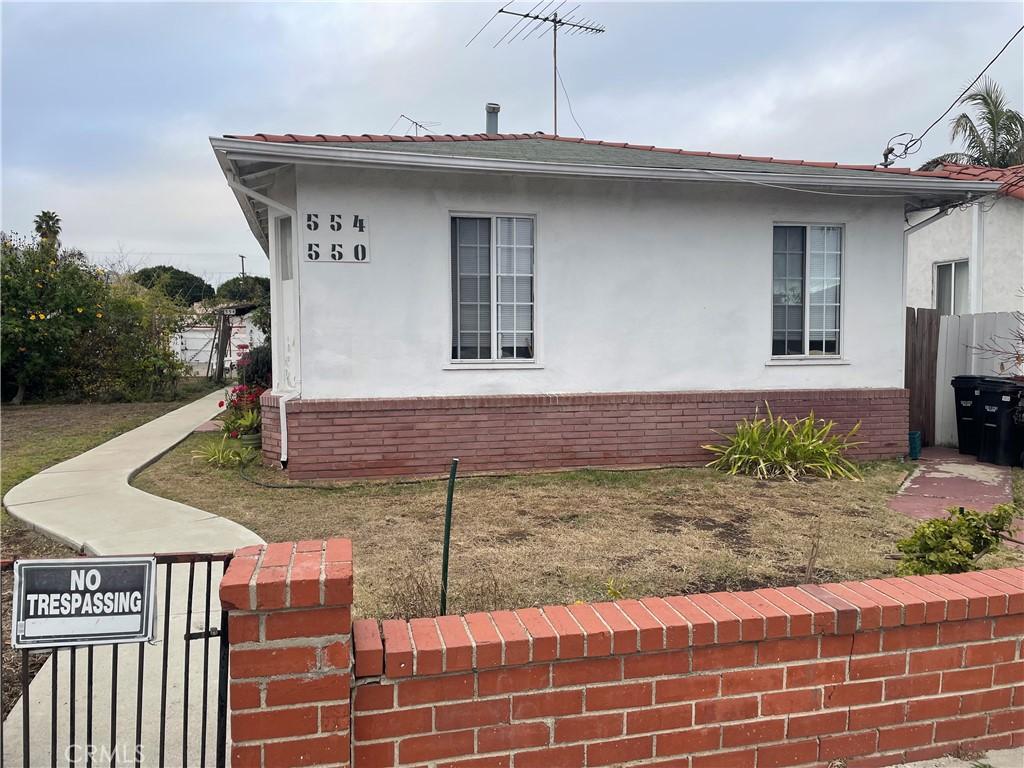 view of side of property with a lawn