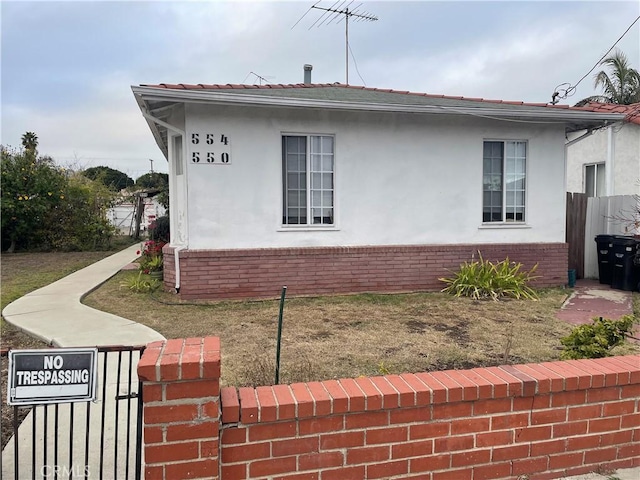 view of side of property with a lawn