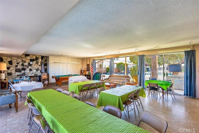 dining space featuring billiards and a textured ceiling