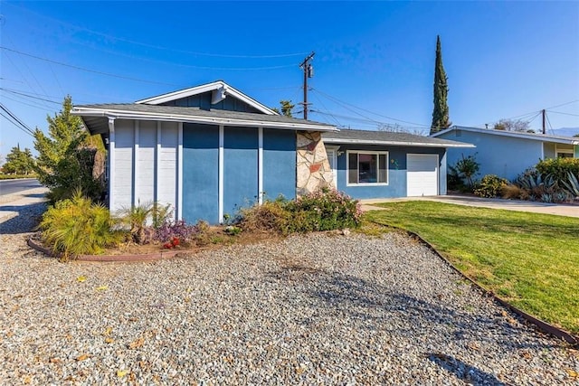 ranch-style house with a front lawn, concrete driveway, board and batten siding, and an attached garage