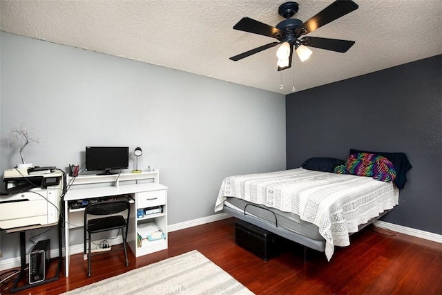 bedroom with ceiling fan, dark hardwood / wood-style floors, and a textured ceiling