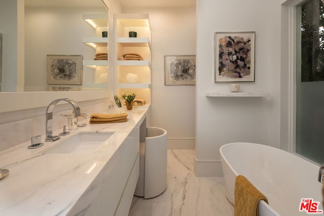 bathroom with vanity and a tub