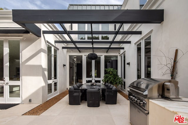 view of patio / terrace with french doors, an outdoor kitchen, and grilling area