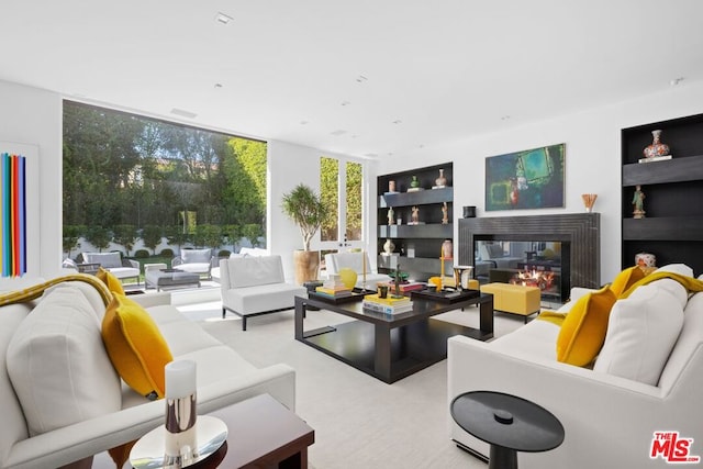 carpeted living room featuring expansive windows and a multi sided fireplace